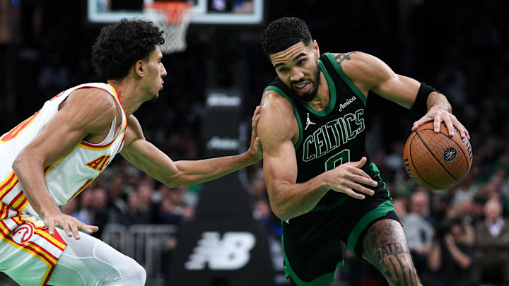 Zaccharie Risacher #10 of the Atlanta Hawks defends Jayson Tatum #0 of the Boston Celtics during the Emirates NBA Cup.