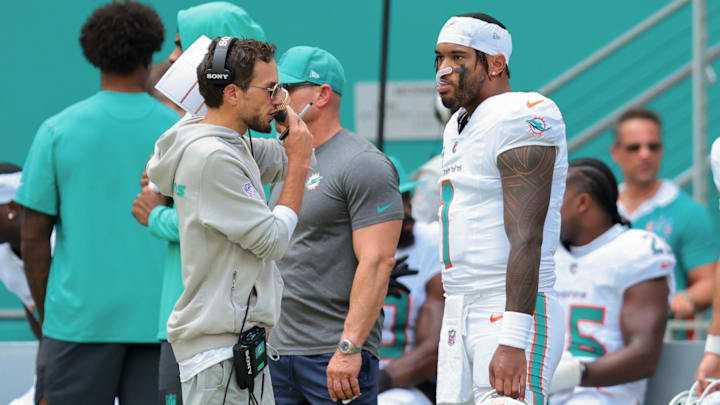 Miami Dolphins head coach Mike McDaniel and quarterback Tua Tagovailoa (1) stand on the sideline against the New England Patriots during the second quarter at Hard Rock Stadium.