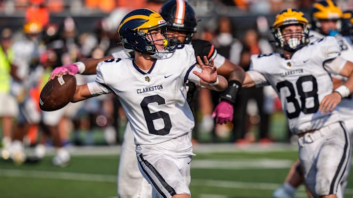 Clarkston QB Alex Waszczenko makes a pass for a first down against Belleville, during the 2024 Xenith Prep Kickoff Classic at Wayne State's Tom Adams Field in Detroit on Friday, Aug. 30, 2024.