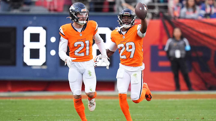 Oct 27, 2024; Denver, Colorado, USA; Denver Broncos cornerback Ja'Quan McMillian (29) celebrates his turnover with cornerback Riley Moss (21) in the second half against the Carolina Panthers at Empower Field at Mile High. Oct 27, 2024; Denver, Colorado, USA; Denver Broncos cornerback Ja'Quan McMillian (29) celebrates his turnover with cornerback Riley Moss (21) in the second half against the Carolina Panthers at Empower Field at Mile High.