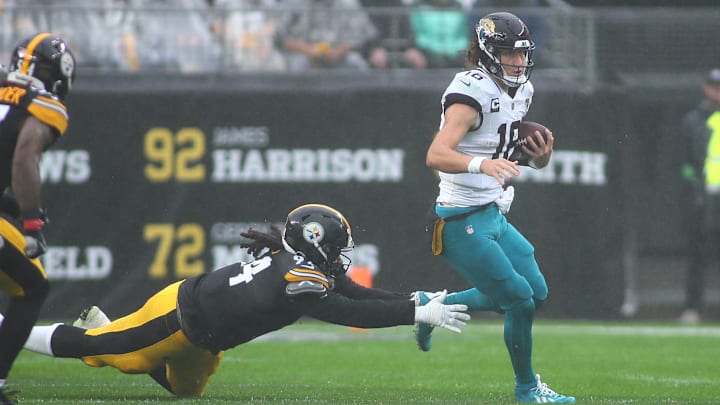 Jacksonville Jaguars Trevor Lawrence (16) slips away from Pittsburgh Steelers Armon Watts (94) while sprinting out of the pocket during the first half at Acrisure Stadium in Pittsburgh, PA on October 29, 2023. Jacksonville Jaguars Trevor Lawrence (16) slips away from Pittsburgh Steelers Armon Watts (94) while sprinting out of the pocket during the first half at Acrisure Stadium in Pittsburgh, PA on October 29, 2023.