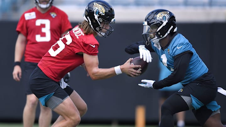 Jacksonville Jaguars quarterback Trevor Lawrence (16) fakes a handoff to running back Travis Etienne Jacksonville Jaguars quarterback Trevor Lawrence (16) fakes a handoff to running back Travis Etienne