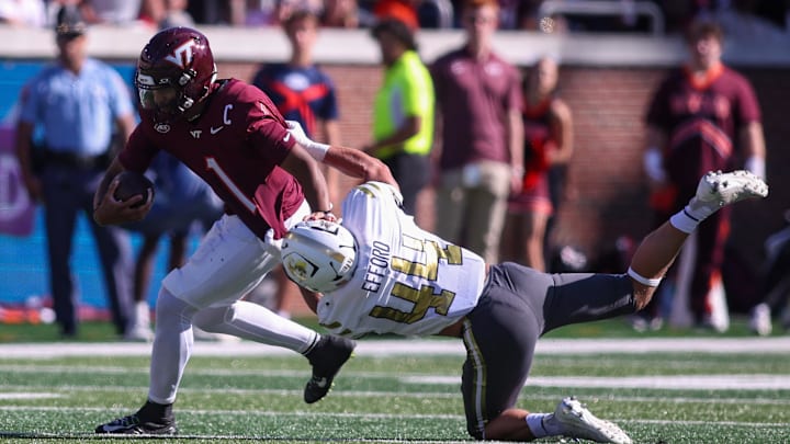 Oct 11, 2025; Atlanta, Ga.; Virginia Tech quarterback Kyron Drones (1) is tackled by Georgia Tech linebacker Kyle Efford (44). Oct 11, 2025; Atlanta, Ga.; Virginia Tech quarterback Kyron Drones (1) is tackled by Georgia Tech linebacker Kyle Efford (44).