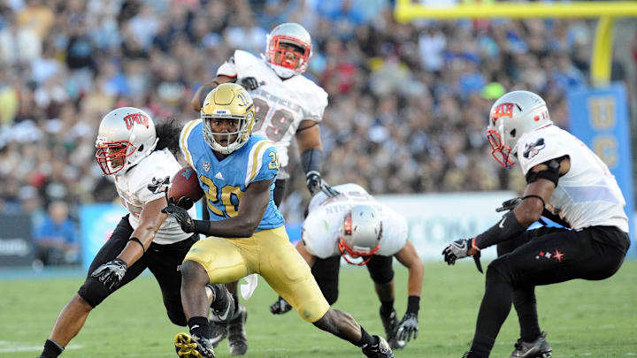 September 10, 2016; Pasadena, CA, USA;  UCLA Bruins running back Brandon Stephens (20) runs the ball against the UNLV Rebels during the first half at Rose Bowl. Mandatory Credit: Gary A. Vasquez-Imagn Images