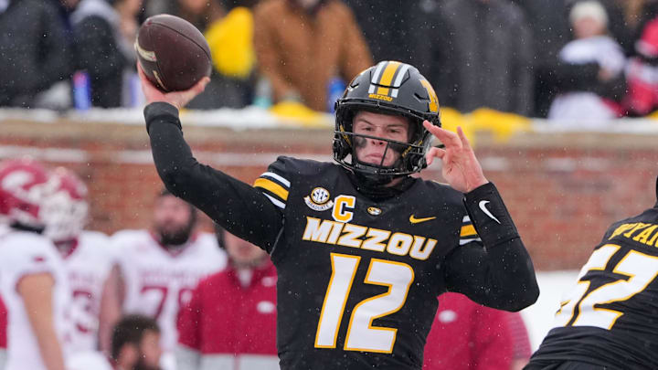 Nov 30, 2024; Columbia, Missouri, USA; Missouri Tigers quarterback Brady Cook (12) throws a pass against the Arkansas Razorbacks during the first half at Faurot Field at Memorial Stadium. Mandatory Credit: Denny Medley-Imagn Images