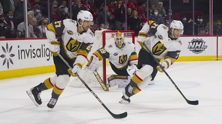 Jan 25, 2022; Raleigh, North Carolina, USA;  Vegas Golden Knights defenseman Shea Theodore (27) and center William Karlsson (71) come up the ice with the puck against the Carolina Hurricanes during the second period at PNC Arena. Mandatory Credit: James Guillory-Imagn Images