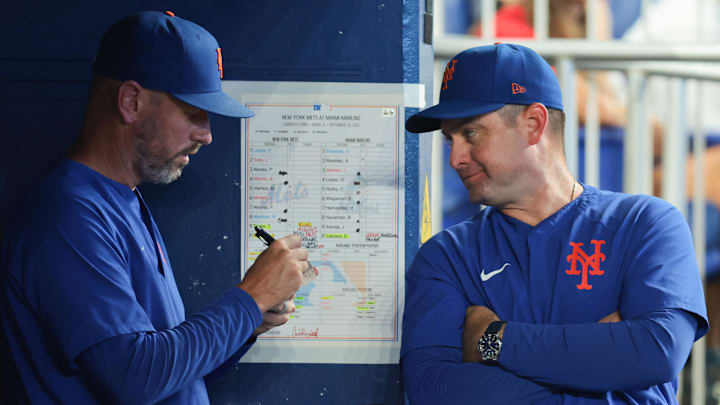 Sep 28, 2025; Miami, Florida, USA; New York Mets manager Carlos Mendoza (64) talks to pitching coach Jeremy Hefner (95) against the Miami Marlins during the eighth inning at loanDepot Park. Mandatory Credit: Sam Navarro-Imagn Images