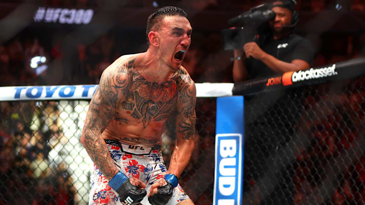 Apr 13, 2024; Las Vegas, Nevada, USA; Max Holloway (blue gloves) reacts after defeating Justin Gaethje (not pictured) during UFC 300 at T-Mobile Arena.