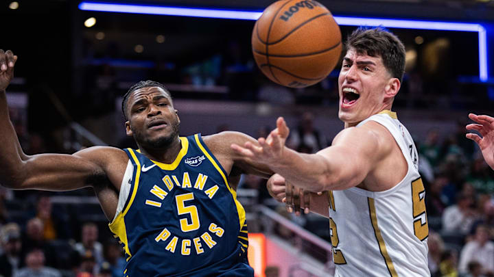 Jan 12, 2026; Indianapolis, Indiana, USA; Indiana Pacers forward Jarace Walker (5) and Boston Celtics center Luka Garza (52) fight for a rebound in the second half at Gainbridge Fieldhouse. Mandatory Credit: Trevor Ruszkowski-Imagn Images