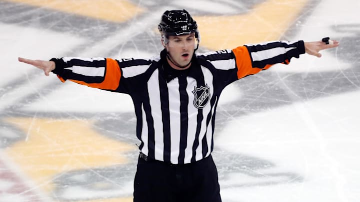 Oct 20, 2022; Pittsburgh, Pennsylvania, USA;  NHL referee Mitch Dunning (20) signals a no goal in the game between the Los Angeles Kings and the Pittsburgh Penguins during the second period at PPG Paints Arena. Mandatory Credit: Charles LeClaire-Imagn Images