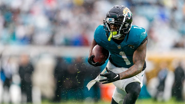 Jacksonville Jaguars running back Travis Etienne Jr. (1) runs the ball against the Tennessee Titans during the second quarter at EverBank Stadium. 