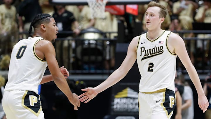 Purdue Boilermakers guard C.J. Cox (0) high-fives guard Fletcher Loyer (2)