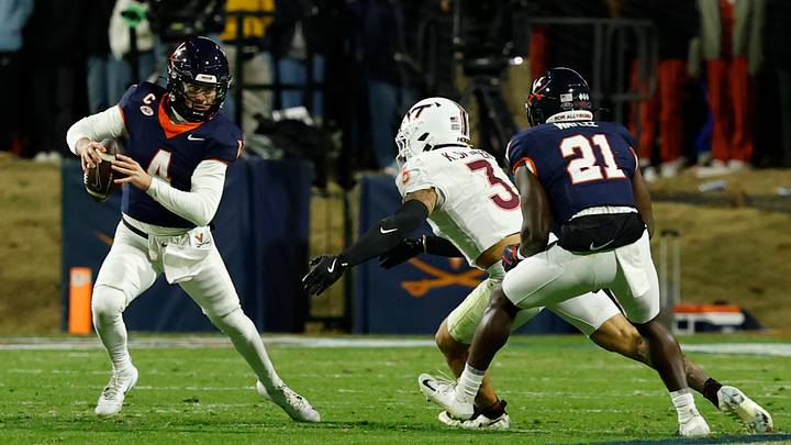 Nov 29, 2025; Charlottesville, Virginia, USA; Virginia Cavaliers quarterback Chandler Morris (4) scrambles from Virginia Tech Hokies linebacker Kaleb Spencer (3) in the second quarter at Scott Stadium. Mandatory Credit: Geoff Burke-Imagn Images Nov 29, 2025; Charlottesville, Virginia, USA; Virginia Cavaliers quarterback Chandler Morris (4) scrambles from Virginia Tech Hokies linebacker Kaleb Spencer (3) in the second quarter at Scott Stadium. Mandatory Credit: Geoff Burke-Imagn Images