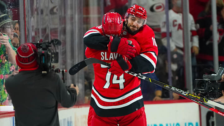 Jan 25, 2022; Raleigh, North Carolina, USA;  Carolina Hurricanes center Vincent Trocheck (16) and defenseman Jaccob Slavin (74) celebrate their victory against the Vegas Golden Knights at PNC Arena. Mandatory Credit: James Guillory-Imagn Images