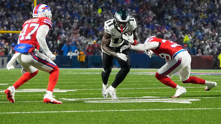 Dec 28, 2025; Orchard Park, New York, USA; Philadelphia Eagles wide receiver A.J. Brown (11) runs after the catch against Buffalo Bills cornerbacks Cam Lewis (39) and Christian Benford (47) during the first quarter at Highmark Stadium. Mandatory Credit: Gregory Fisher-Imagn Images