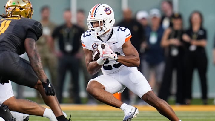 Aug 29, 2025; Waco, Texas, USA; Auburn Tigers cornerback Jay Crawford (23) runs the ball against Baylor Bears linebacker Keaton Thomas (11) during the first half at McLane Stadium. Mandatory Credit: Chris Jones-Imagn Images Aug 29, 2025; Waco, Texas, USA; Auburn Tigers cornerback Jay Crawford (23) runs the ball against Baylor Bears linebacker Keaton Thomas (11) during the first half at McLane Stadium. Mandatory Credit: Chris Jones-Imagn Images