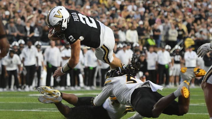 Oct 25, 2025; Nashville, Tennessee, USA; Vanderbilt Commodores quarterback Diego Pavia (2) dives over Missouri Tigers defenders for a one-yard touchdown during the fourth quarter at FirstBank Stadium. Mandatory Credit: Steve Roberts-Imagn Images Oct 25, 2025; Nashville, Tennessee, USA; Vanderbilt Commodores quarterback Diego Pavia (2) dives over Missouri Tigers defenders for a one-yard touchdown during the fourth quarter at FirstBank Stadium. Mandatory Credit: Steve Roberts-Imagn Images