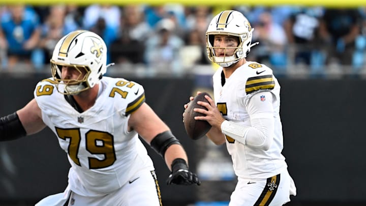 Nov 9, 2025; Charlotte, North Carolina, USA;  New Orleans Saints quarterback Tyler Shough (6) looks to pass as center Luke Fortner (79) blocks in the fourth quarter at Bank of America Stadium. Mandatory Credit: Bob Donnan-Imagn Images
