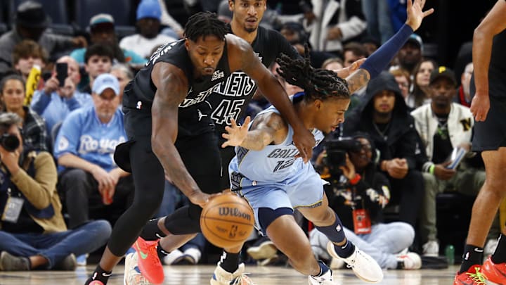 Dec 13, 2024; Memphis, Tennessee, USA; Brooklyn Nets forward Dorian Finney-Smith (28) and Memphis Grizzlies guard Ja Morant (12) battle for a loose ball during the first quarter at FedExForum. Mandatory Credit: Petre Thomas-Imagn Images