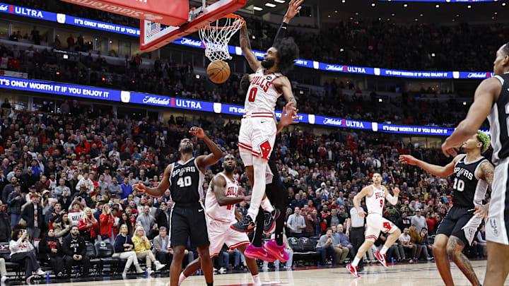 Jan 6, 2025; Chicago, Illinois, USA; Chicago Bulls guard Coby White (0) shoots against San Antonio Spurs center Victor Wembanyama (1)