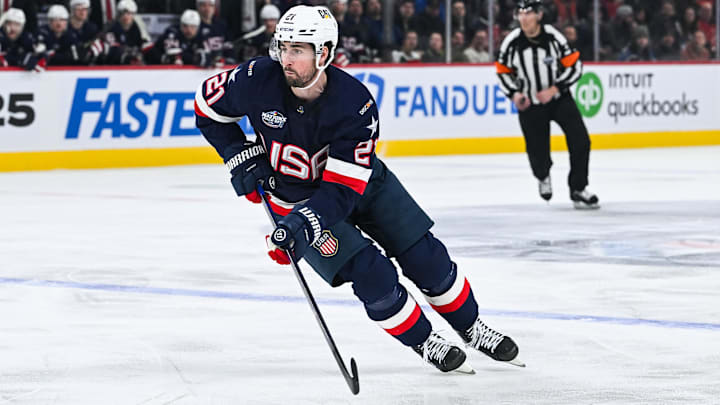 Feb 13, 2025; Montreal, Quebec, CAN; [Imagn Images direct customers only] Team USA forward Dylan Larkin (21) plays the puck against Team Finland in the first period during a 4 Nations Face-Off ice hockey game at Bell Centre. Mandatory Credit: David Kirouac-Imagn Images