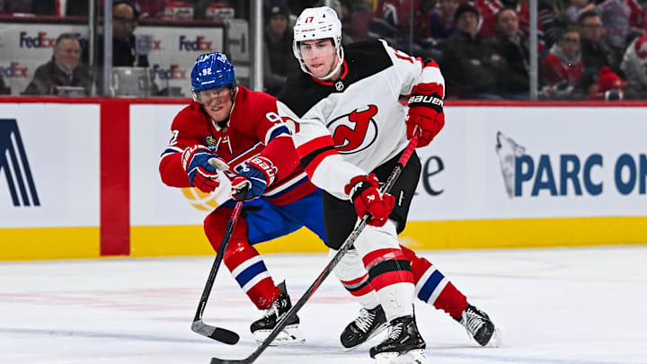 Feb 8, 2025; Montreal, Quebec, CAN; New Jersey Devils defenseman Simon Nemec (17) plays the puck against Montreal Canadiens right wing Patrik Laine (92) during the first period at Bell Centre. Mandatory Credit: David Kirouac-Imagn Images
