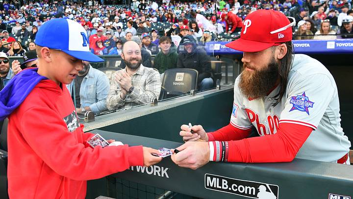 Apr 4, 2026; Denver, Colorado, USA; Philadelphia Phillies outfielder Brandon Marsh (16) signs a card for a fan before the game against the Colorado Rockies at Coors Field. Mandatory Credit: Christopher Hanewinckel-Imagn Images