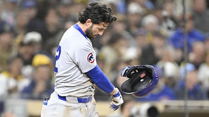 Chicago Cubs shortstop Dansby Swanson throws his helmet after striking out in the ninth inning against the San Diego Padres.