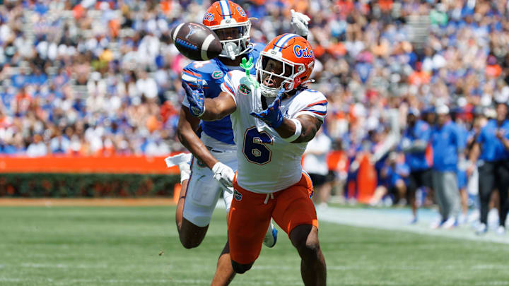 Apr 12, 2025; Gainesville, FL, USA; Florida Gators wide receiver Dallas Wilson (6) attempts to catch a pass over Florida Gators defensive back Teddy Foster (4) during the first half at Ben Hill Griffin Stadium. Mandatory Credit: Matt Pendleton-Imagn Images
