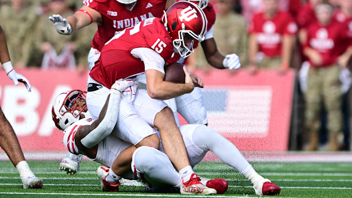Indiana Hoosiers quarterback Fernando Mendoza (15) is sacked by Wisconsin Badgers linebacker Darryl Peterson (17) during the second quarter at Memorial Stadium. 