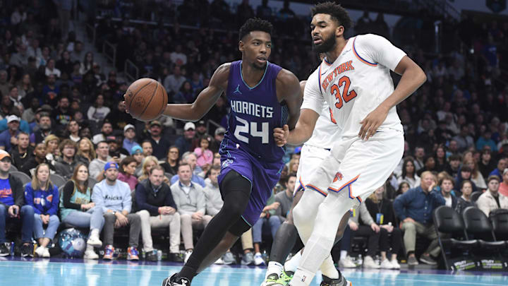 Nov 29, 2024; Charlotte, North Carolina, USA;  Charlotte Hornets forward Brandon Miller (24) drives past New York Knicks center/forward Karl-Anthony Towns (32) during the second half at the Spectrum Center. Mandatory Credit: Sam Sharpe-Imagn Images