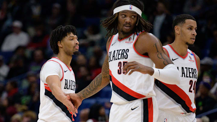 Jan 8, 2025; New Orleans, Louisiana, USA; Portland Trail Blazers guard Anfernee Simons (1) and center Robert Williams III (35) celebrate next to forward Kris Murray (24) during the first half against the New Orleans Pelicans at Smoothie King Center. Mandatory Credit: Matthew Hinton-Imagn Images