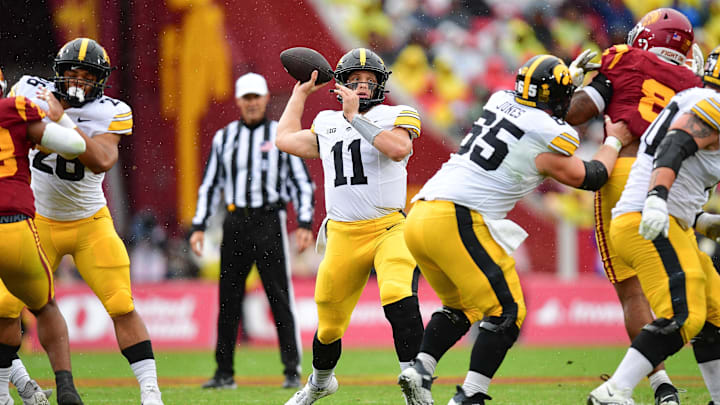 Nov 15, 2025; Los Angeles, California, USA; Iowa Hawkeyes quarterback Mark Gronowski (11) throws against the Southern California Trojans during the first half at the Los Angeles Memorial Coliseum. Mandatory Credit: Gary A. Vasquez-Imagn Images