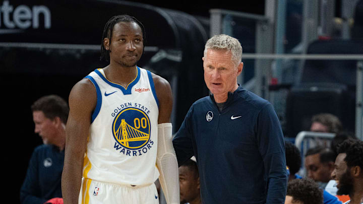 October 20, 2023; San Francisco, California, USA; Golden State Warriors head coach Steve Kerr (right) talks to forward Jonathan Kuminga (00) during the third quarter against the San Antonio Spurs at Chase Center. Mandatory Credit: Kyle Terada-Imagn Images