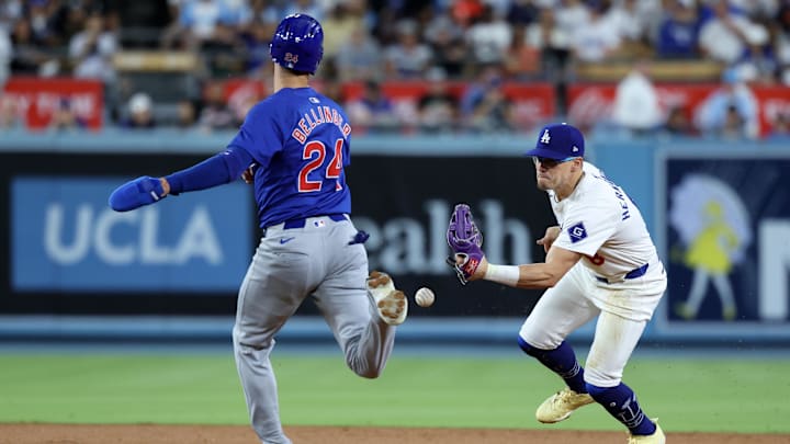 Sep 10, 2024; Los Angeles, California, USA;  Los Angeles Dodgers second baseman Enrique Hernandez (8) makes an error as he attempts to tag Chicago Cubs right fielder Cody Bellinger (24) during the eighth inning at Dodger Stadium. Mandatory Credit: Kiyoshi Mio-Imagn Images