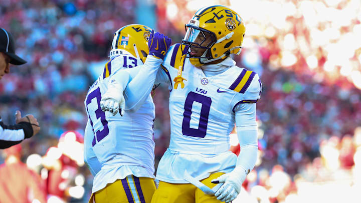Nov 29, 2025; Norman, Oklahoma, USA;  Louisiana State Tigers defensive back A.J. Haulcy (13) and Louisiana State Tigers safety Tamarcus Cooley (0) react during the first half against the Oklahoma Sooners at Gaylord Family-Oklahoma Memorial Stadium. Mandatory Credit: Kevin Jairaj-Imagn Images