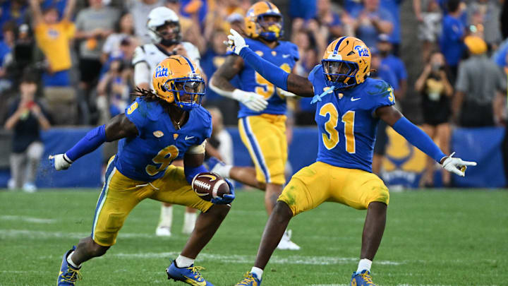 Sep 14, 2024; Pittsburgh, Pennsylvania, USA; Pittsburgh Panthers linebacker Kyle Louis celebrates with linebacker Rasheem Biles (31) after intercepting West Virginia Mountaineers quarterback Garrett Greene (6) in the fourth quarter at Acrisure Stadium. Mandatory Credit: Barry Reeger-Image Images