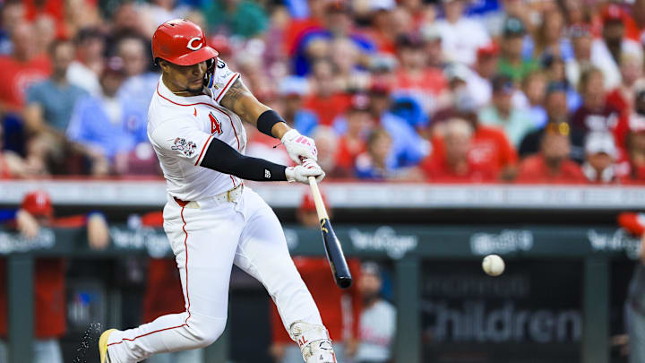 Aug 12, 2025; Cincinnati, Ohio, USA; Cincinnati Reds third baseman Santiago Espinal (4) hits a single in the third inning against the Philadelphia Phillies at Great American Ball Park. Mandatory Credit: Katie Stratman-Imagn Images
