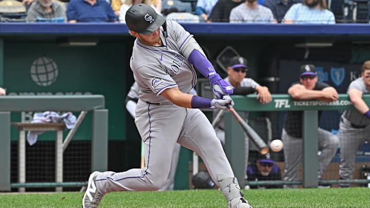 Apr 24, 2025; Kansas City, Missouri, USA;  Colorado Rockies catcher Hunter Goodman (15) drives in a run with a single in the first inning against the Kansas City Royals at Kauffman Stadium. Mandatory Credit: Peter Aiken-Imagn Images