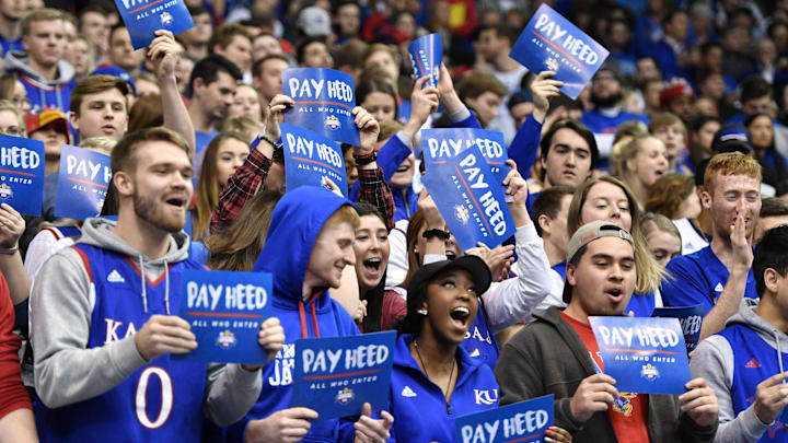 Jan 13, 2018; Lawrence, KS, USA; Kansas Jayhawks students and fans hold \"Pay Heed\" signs during the Sunflower Showdown