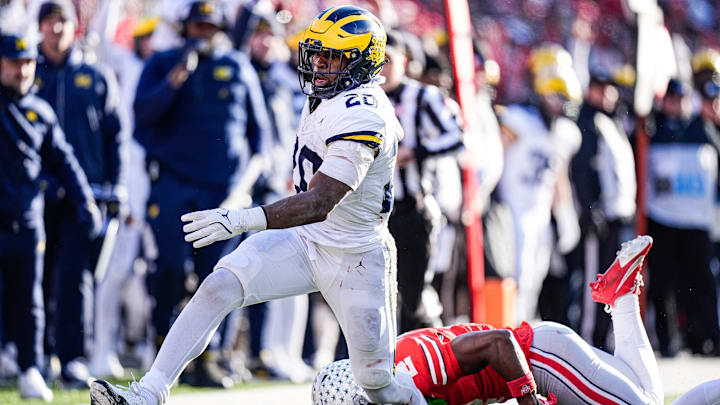 Michigan running back Kalel Mullings (20) runs against Ohio State safety Caleb Downs (2)during the second half at Ohio Stadium in Columbus, Ohio on Saturday, Nov. 30, 2024.