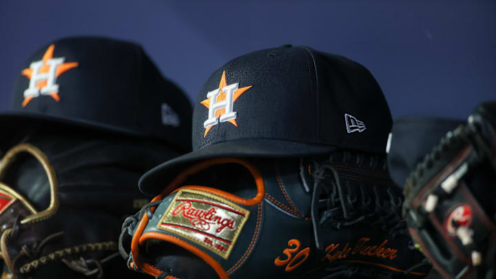 Apr 21, 2023; Atlanta, Georgia, USA; A detailed view of a Houston Astros hat and glove in the dugout against the Atlanta Braves in the fifth inning at Truist Park. Apr 21, 2023; Atlanta, Georgia, USA; A detailed view of a Houston Astros hat and glove in the dugout against the Atlanta Braves in the fifth inning at Truist Park.