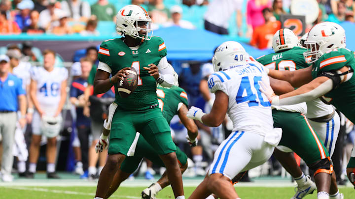 Nov 2, 2024; Miami Gardens, Florida, USA; Miami Hurricanes quarterback Cam Ward (1) looks for a passing option against the Duke Blue Devils during the second quarter at Hard Rock Stadium. Mandatory Credit: Sam Navarro-Imagn Images