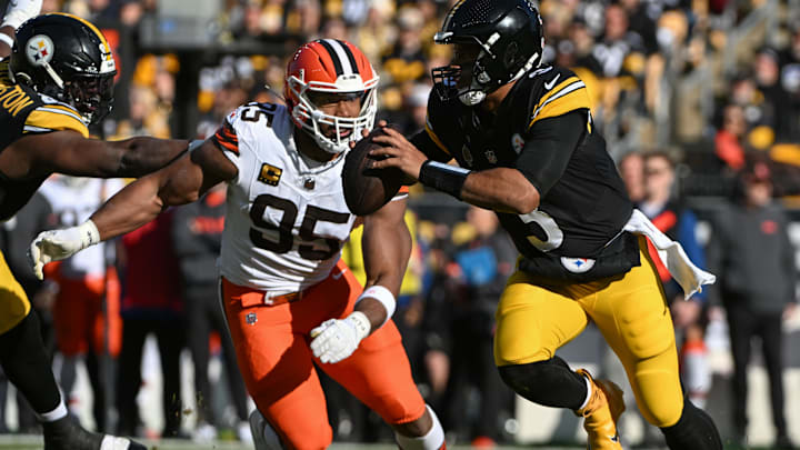 Dec 8, 2024; Pittsburgh, Pennsylvania, USA; Pittsburgh Steelers quarterback Russell Wilson (3) is chased by Cleveland Browns defensive end Myles Garrett (95) during the first quarter at Acrisure Stadium. Mandatory Credit: Barry Reeger-Imagn Images