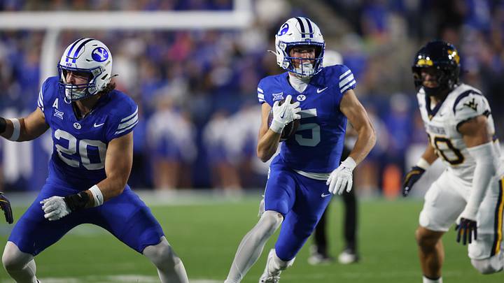 Oct 3, 2025; Provo, Utah, USA; Brigham Young Cougars wide receiver Cody Hagen (5) runs after a catch behind the block of tight end Carsen Ryan (20) during the first quarter against the West Virginia Mountaineers at LaVell Edwards Stadium. Mandatory Credit: Rob Gray-Imagn Images Oct 3, 2025; Provo, Utah, USA; Brigham Young Cougars wide receiver Cody Hagen (5) runs after a catch behind the block of tight end Carsen Ryan (20) during the first quarter against the West Virginia Mountaineers at LaVell Edwards Stadium. Mandatory Credit: Rob Gray-Imagn Images