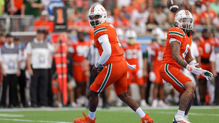 Dec 28, 2024; Orlando, FL, USA; a snap goes past Miami Hurricanes quarterback Cam Ward (1) against the Iowa State Cyclones in the first quarter during the Pop Tarts bowl at Camping World Stadium. Dec 28, 2024; Orlando, FL, USA; a snap goes past Miami Hurricanes quarterback Cam Ward (1) against the Iowa State Cyclones in the first quarter during the Pop Tarts bowl at Camping World Stadium.