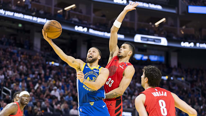 Portland Trail Blazers forward Toumani Camara (33) fouls Golden State Warriors guard Stephen Curry (30) during the second quarter at Chase Center. Mandatory Credit: John Hefti-Imagn Images