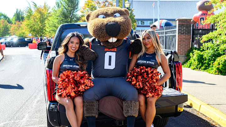 Sep 21, 2024; Corvallis, Oregon, USA; Oregon State Beavers cheerleaders pose with Benny the mascot before the game against the Purdue Boilermakers at Reser Stadium. Mandatory Credit: Craig Strobeck-Imagn Images