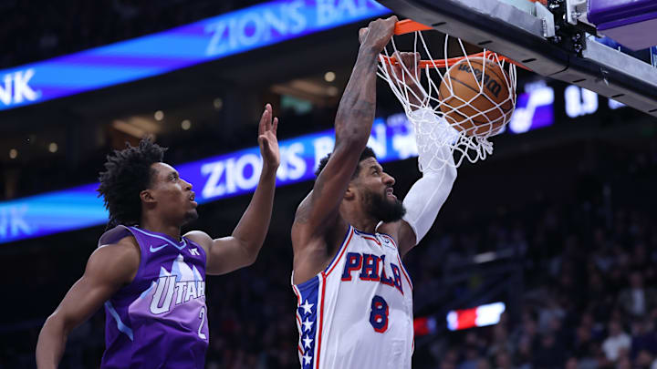 Dec 28, 2024; Salt Lake City, Utah, USA; Philadelphia 76ers forward Paul George (8) dunks the ball past Utah Jazz guard Collin Sexton (2) during the second quarter at Delta Center. Mandatory Credit: Rob Gray-Imagn Images