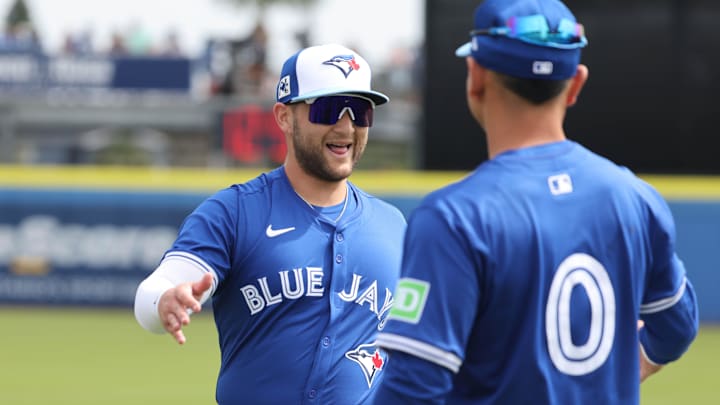 Dunedin, Florida, USA; Toronto Blue Jays shortstop Bo Bichette (11) and second base Andrés Gimenez (0) before the game against the New York Yankees at TD Ballpark.